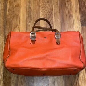 I Santi Large Pebbled Orange Leather Weekender Tote with‎ brown handles & strap.